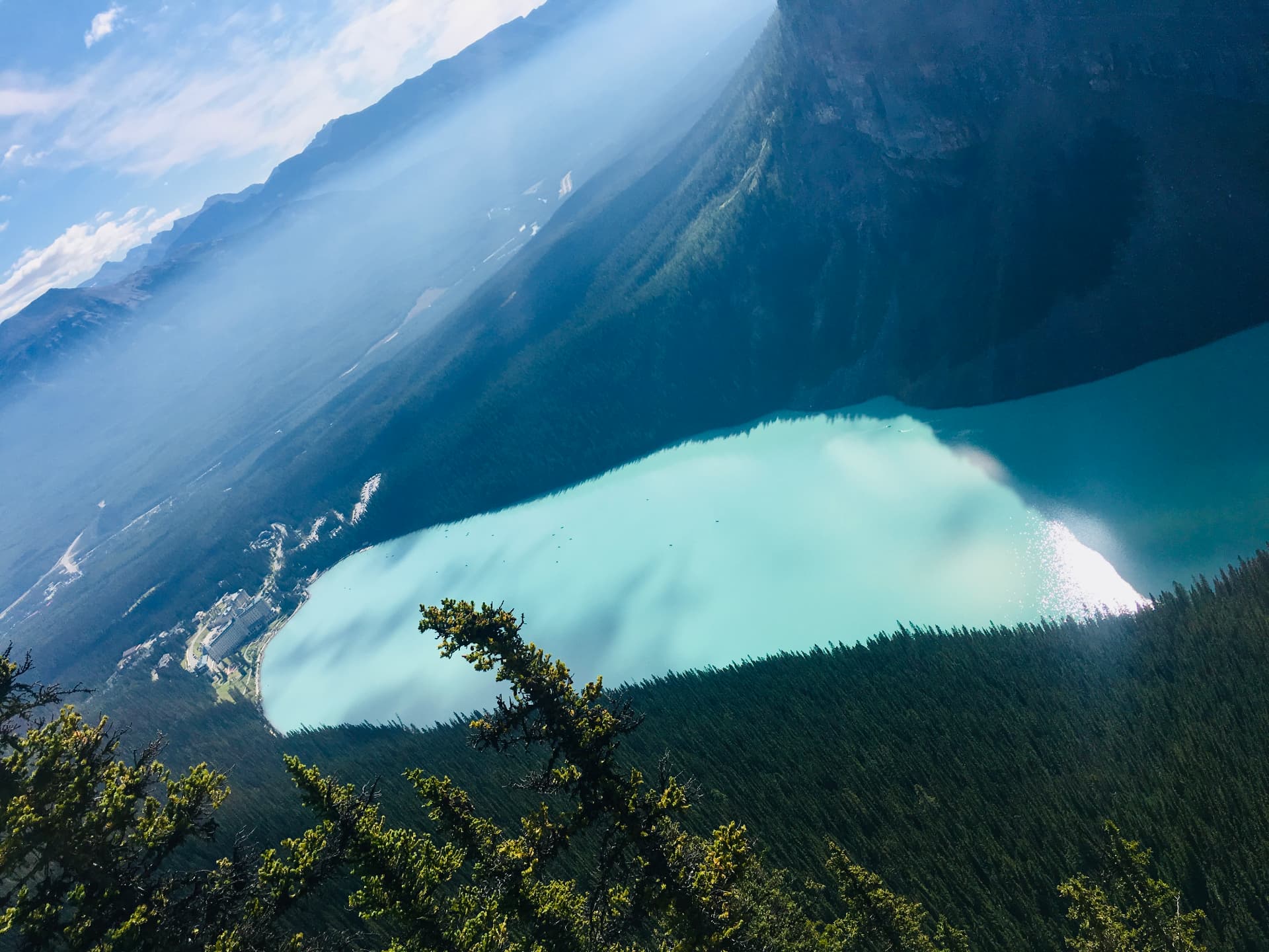 A turquoise lake seen from a mountain slope